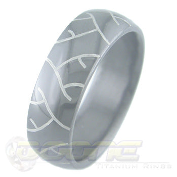 tread marks design laser engraved on black zirconium ring with white on black motif known as tuxedo