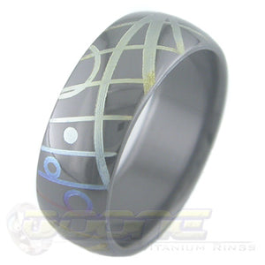 geometric design laser engraved on black zirconium ring with varied color fades known as chroma 