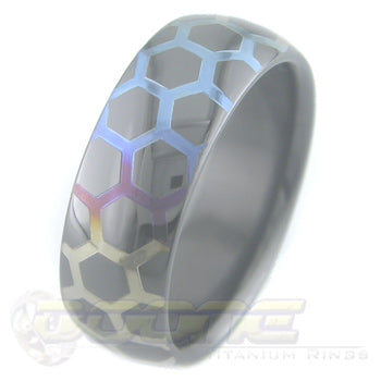 honey comb design laser engraved on black zirconium ring with varied color fades known as chroma