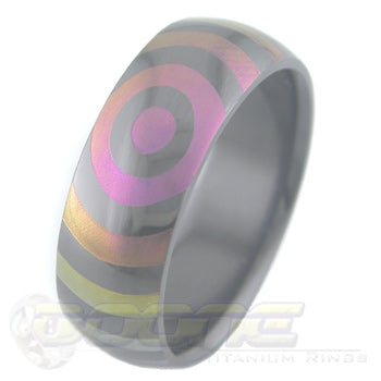 orbit design laser engraved on black zirconium ring with varied color fades known as chroma