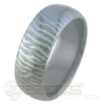 siberian tiger claw mark design laser engraved on black zirconium ring with varied color fades known as chroma
