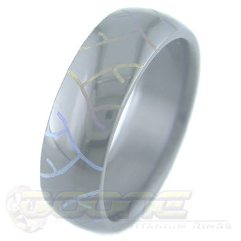 tread marks design laser engraved on black zirconium ring with varied color fades  known as chroma
